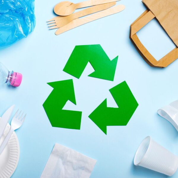 A recycling symbol surrounded by trash